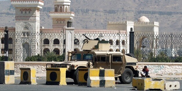 A Shiite Huthi militiaman sits near a tank confiscated from the army in the area around the presidential palace in the capital Sanaa, on January 22, 2015. Shiite militiamen maintained a tight grip on Yemen's capital today with fighters deployed around the presidential palace despite a deal to end what authorities termed a coup attempt. President Abdrabuh Mansur Hadi's abducted chief of staff remained in the hands of the Huthi militia, which seized control of most of Sanaa in September after sweeping south from its stronghold in the northern highlands. AFP PHOTO / MOHAMMED HUWAIS (Photo credit should read MOHAMMED HUWAIS/AFP/Getty Images)