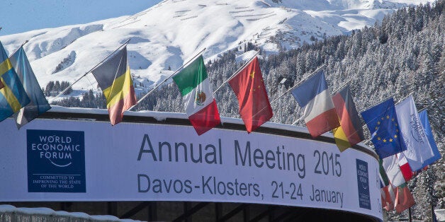 Flags hang on the roof of the Congress Hall were the World Economic Forum will take place in Davos, Switzerland, Monday, Jan. 19, 2015. The world's financial and political elite will head this week to the Swiss Alps for 2015's gathering of the World Economic Forum at the Swiss ski resort of Davos. (AP Photo/Michel Euler)