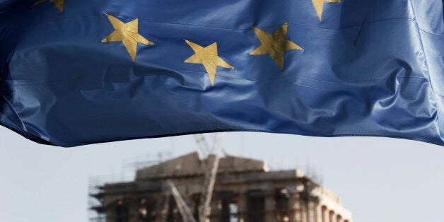 A European Union flag billows in the wind as the ruins of the 5th century BC Parthenon temple is seen in the background on th