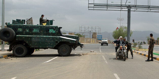 Yemeni soldiers search a motorbike at a checkpoint on a street leading to the US embassy compound in Sanaa on August 4, 2013. Security measures were particularly strict in the Yemeni capital after Washington held urgent talks on an Al-Qaeda threat that prompted two dozen embassies and consulates to temporarily halt their services in many capitals in the region. AFP PHOTO/ MOHAMMED HUWAIS (Photo credit should read MOHAMMED HUWAIS/AFP/Getty Images)