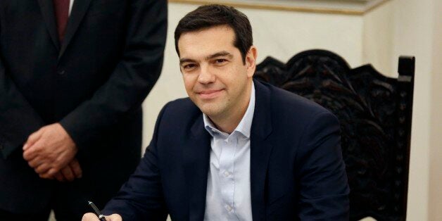 Greece's Prime Minister Alexis Tsipras poses for the photographers after taking a secular oath at the Presidential Palace in Athens, Monday, Jan. 26, 2015. Radical left leader Alexis Tsipras has been sworn in as Greece's new prime minister, becoming the youngest man to hold the post in 150 years. The 40-year-old broke with tradition and took a secular oath rather than the Greek Orthodox religious ceremony with which prime ministers are usually sworn in.(AP Photo/Thanassis Stavrakis)