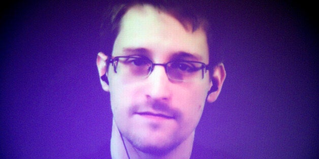 Former U.S. National Security Agency contractor Edward Snowden, who is in Moscow, is seen on a giant screen during a live vid