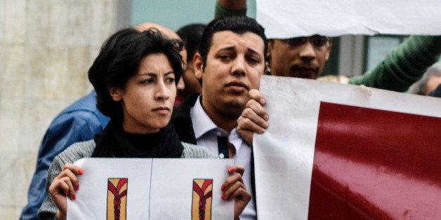 In this Saturday, Jan. 24, 2015 photo, 32-year-old mother Shaimaa el-Sabbagh holds a poster during a protest in downtown Cairo. Egypt has sought to distance the police from the weekend shooting death of el-Sabbagh, saying a forensic examination shows she was killed by a type of projectile that is "absolutely" not used by security forces. A senior official from the Interior Ministry, which is in charge of the police, also dismissed as "inconsequential" video clips showing two masked, black-clad policemen pointing their rifles in her direction as gunshots rang out and a voice commanded "fire." (AP Photo/Mohammed El-Raaei)