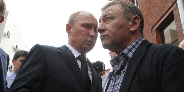 SAINT PETERSBURG, RUSSIA - AUGUST 09: Russian President Vladimir Putin (L) and billionaire Arkady Rotenberg (R) attend the funeral of his former judo trainer Anatoly Rakhlin on August 9, 2013 in Saint Petersburg, Russia. Rahklin died on August 7 at 75 years old. (Photo by Sasha Mordovets/Getty Images)