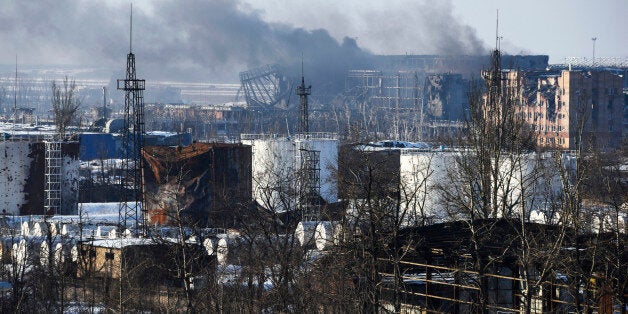 In this Thursday, Jan. 15, 2015 photo, smoke rises over the new terminal of Donetsk airport in Donetsk, Eastern Ukraine. Russian-backed separatists announced Thursday they had captured the shattered remains of the Donetsk airport terminal and plan to claw back more territory, further dashing hopes for a lasting peace agreement. (AP Photo/Mstyslav Chernov)