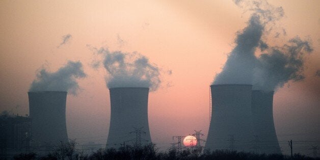 This photo taken on December 22, 2014 shows smoke rising in the air from a power plant near Hengshui in China's Hebei provinc