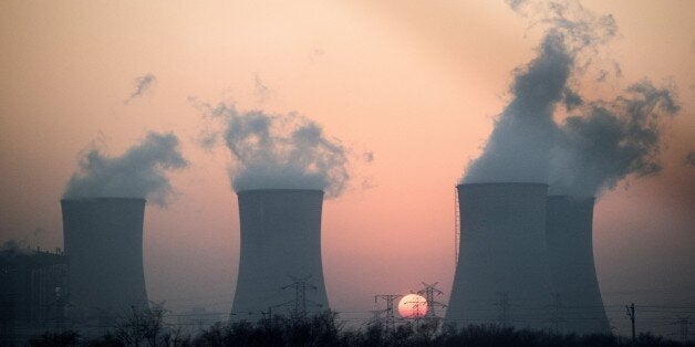 This photo taken on December 22, 2014 shows smoke rising in the air from a power plant near Hengshui in China's Hebei province. China has for years been hit by heavy air pollution, caused by enormous use of coal to generate electricity to power a booming economy, and by more vehicles on the roads. China said in November that it aims to cap its annual coal use at 4.2 billion tonnes by 2020, a one-sixth increase on current consumption, already by far the world's largest. AFP PHOTO / FRED DUFOUR (Photo credit should read FRED DUFOUR/AFP/Getty Images)