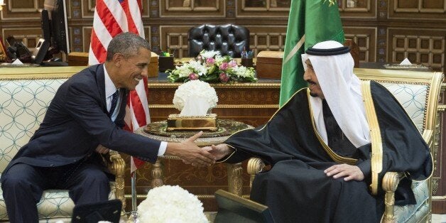 Saudi's newly appointed King Salman (R) shakes hands with US President Barack Obama at Erga Palace in Riyadh on January 27, 2