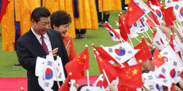 SEOUL, SOUTH KOREA - JULY 03: Chinese President Xi Jinping and South Korean President Park Geun-Hye greet South Korean child