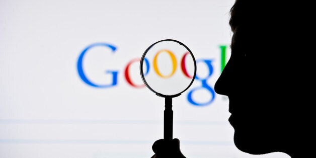 BERLIN, GERMANY - JUNE 02: A silhouette of a man and a magnifying glass is seen in front of a screen on which the Google search engine is displayed on June 02, 2014 in Berlin, Germany.(Photo by Michael Gottschalk/Photothek via Getty Images)