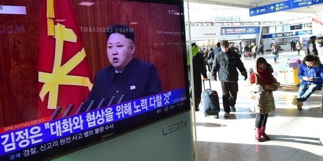 Travellers walk past a television screen showing North Korean leader Kim Jong-Un's New Year speech, at a railroad station in Seoul on January 1, 2015. North Korean leader Kim Jong-Un said he was open to the 'highest-level' talks with South Korea as he called for an improvement in strained cross-border relations. AFP PHOTO / JUNG YEON-JE (Photo credit should read JUNG YEON-JE/AFP/Getty Images)