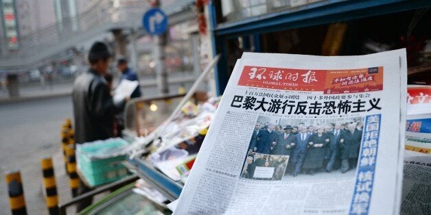 Chinese newspaper front pages show their coverage of marches held in response to the recent Islamist attacks that killed 17 people, most at the Paris offices of satirical magazine Charlie Hebdo, at a newsstand in Beijing on January 12, 2015. About a hundred thousand people rallied worldwide in solidarity with France on January 11, with marchers across Europe and the Middle East chanting 'Je suis Charlie' and holding pens in the air. AFP PHOTO / WANG ZHAO (Photo credit should read WANG ZHAO/AFP/Getty Images)