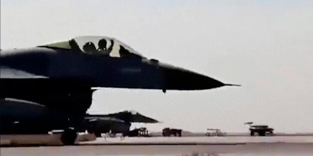 In this image made from Wednesday, Feb. 4, 2015, video provided by Jordanian military via Roya TV, an air force pilot raises