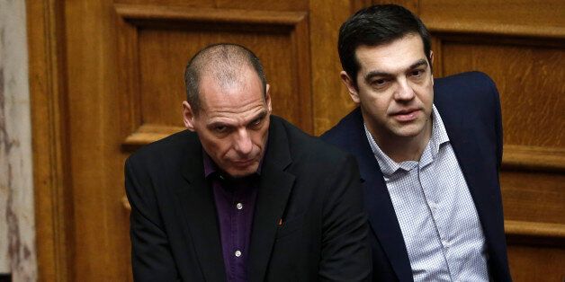 Greek Minister Alexis Tsipras, right and HIS Finance Minister Yanis Varoufakis look on during the vote for the president of Greece's parliament in Athens, on Friday, Feb. 6, 2015. Barely 10 days after radical left-wing Syriza was swept to power in Athens, analysts expect a compromise over Greece's debts to emerge, allowing it to remain a member of the 19-country eurozone. The finance ministers of the 19-country eurozone are to meet at a special meeting Wednesday on the eve of a summit of European Union leaders to discuss Greeceâs debts. (AP Photo/Petros Giannakouris )