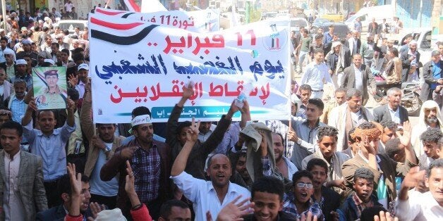 IBB, YEMEN - FEBRUARY 11: Hundreds march toward the municipality building during a demonstration rally to mark the fourth anniversary of the 2011 revolution, beginning of Yemen's uprising, on Taiz street in Ibb, Yemen on February 11, 2015. (Photo by Adil es-Sharee/Anadolu Agency/Getty Images)