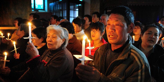 Chinese Catholic pray as they attend an Easter service at the historic South Cathedral in Beijing on April 7, 2012. Easter ceremonies traditionally stress the suffering of the Catholic Church and the world, an emphasis that is being particularly keenly felt this year with multiple conflicts around the world and tensions within the Church. The Holy Week celebrations take place amid concerns over the fate of Christians in the Middle East in the face of rising Islamism and violent conflict, especially in Syria which has a large Christian minority. AFP PHOTO/Mark RALSTON (Photo credit should read MARK RALSTON/AFP/Getty Images)