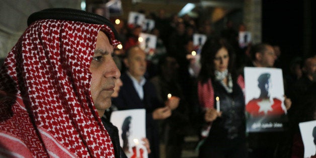 AMMAN, JORDAN- FEBRUARY 08: Jordanian journalists hold a candlelight vigil expressing their solidarity for a pilot murdered by the Islamic State (ISIS) group, on February 8, 2015 in Amman, Jordan. Jordan has launched dozens of airstrikes against ISIS since the militant group released a video of them burning to death Jordanian pilot Lt Moaz al-Kasaesbeh. (Photo by Jordan Pix/Getty Images)