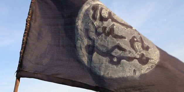 A Boko Haram flag flutters from an abandoned command post in Gamboru deserted after Chadian troops chased them from the borde