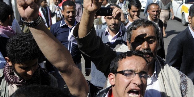 SANA'A, YEMEN - FEBRUARY 14: Yemenis shout slogans during a rally against the occupation of the capital by Shiite Houthi rebels in front of Ministry of youth and sport building at Zubeyri Street on February 14, 2015 in the capital Sanaa, Yemen. (Photo by Mohammed Hamoud/Anadolu Agency/Getty Images)