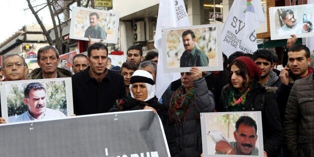 Members of the Kurdish community wave flags and banners of convicted Kurdistan Worker's Party (PKK) leader Abdullah Ocalan during a demonstration calling for Ocalan's release in Ankara on February 15, 2015. Ocalan was captured by Turkish undercover agents in Kenya in 1999, brought back to Turkey and sentenced to death. His sentence was later commuted to life. AFP PHOTO/ADEM ALTAN (Photo credit should read ADEM ALTAN/AFP/Getty Images)