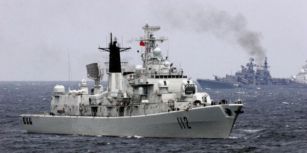 SHANDONG PENINSULA, CHINA - AUGUST 23: (CHINA OUT) A Chinese navy vessel attends an offshore blockade exercise during the third phase of the Sino-Russian 'Peace Mission 2005' joint military exercise on August 23, 2005 near Shandong Peninsula, China. More than 7,000 Chinese troops and 1,800 Russians with military vessels, fighter jets and amphibious tanks took part in the live ammunition combat practice, according to state media. (Photo by China Photos/Getty Images)