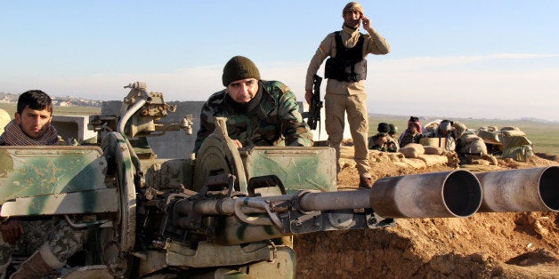 In this Tuesday, Jan. 20, 2015 image released by the Kurdistan Region Security Council (KRSC), Kurdish peshmerga forces prepare their positions on the front line for battle against Islamic State group positions in northern Iraq. Kurdish Regional Security Council said Wednesday, Jan. 21, 2015 that Kurdish peshmerga fighters launched a new offensive to secure areas southeast and southwest of the dam. (AP Photo/Kurdistan Region Security Council)