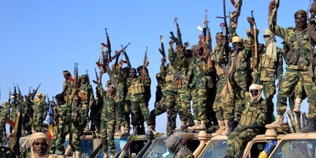 Chadian soldiers gather on February 1, 2015 near the Nigerian town of Gamboru, just accros the border from Cameroon. In a deserted Gamboru, Chadian forces carried out clean-up operations after entering the town and retaking it from Boko Haram, which seized control months ago. AFP PHOTO / MARLE (Photo credit should read MARLE/AFP/Getty Images)