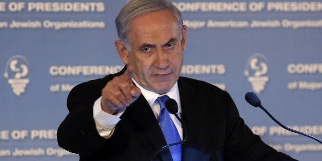 Israeli Prime Minister Benjamin Netanyahu gestures as he delivers a speech during the Presidents Conference of Major American Jewish organizations in Jerusalem on February 16, 2015. Prime Minister Helle Thorning-Schmidt urged Danish Jews not to emigrate despite a call from her Israeli counterpart Benjamin Netanyahu for European Jews to move to Israel following the Copenhagen attacks. AFP PHOTO/GALI TIBBON (Photo credit should read GALI TIBBON/AFP/Getty Images)