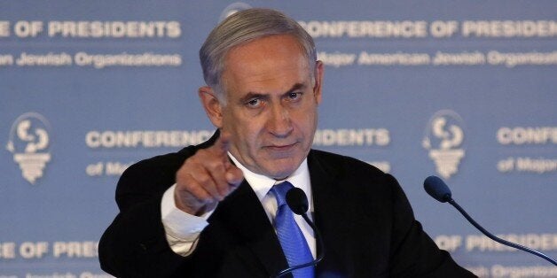 Israeli Prime Minister Benjamin Netanyahu gestures as he delivers a speech during the Presidents Conference of Major American Jewish organizations in Jerusalem on February 16, 2015. Prime Minister Helle Thorning-Schmidt urged Danish Jews not to emigrate despite a call from her Israeli counterpart Benjamin Netanyahu for European Jews to move to Israel following the Copenhagen attacks. AFP PHOTO/GALI TIBBON (Photo credit should read GALI TIBBON/AFP/Getty Images)