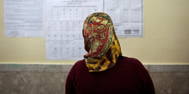 ABU GHOSH, ISRAEL - JANUARY 22: (ISRAEL OUT) A woman looks at the information hung on a wall as Israeli Arabs cast their vote during the Israeli General Election on January 22, 2013 in Abu Ghosh, Israel. The latest opinion polls suggest that current Prime Minister Benjamin Netanyahu will return to office, albeit with a reduced majority. (Photo by Uriel Sinai/Getty Images)