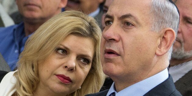 Israeli Prime Minister Benjamin Netanyhau (R) and his wife Sara attend a ceremony to bury the ashes of British WW1 veteran hero Lt. Col. John Henry Patterson and his wife Frances Helena on December 4, 2014 in the Israeli military cemetery of Avihayil in Netanya, north of Tel Aviv. Patterson, who was a Protestant, gained iconic status as the first commander to lead Jewish forces onto the field of battle during the Great War - playing a critical part in the history of Zionism. Patterson's final wishes was that both he and his wife eventually be interred in Israel, ideally, with or close to the men he commanded during World War I. AFP PHOTO / JACK GUEZ (Photo credit should read JACK GUEZ/AFP/Getty Images)