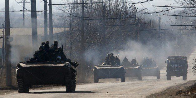 A column of Ukrainian forces rides from Artemivsk, in the Donetsk region, eastern Ukraine on February 22, 2015. The Ukrainian army and the rebels announced on Sunday, they had agreed to pull back heavy weapons from the frontline, an important and overdue part of the truce. But the only visible sign of compliance with the ceasefire agreement was a late-Saturday prisoner swap of nearly 200 fighters detained by both sides. AFP PHOTO/ANATOLII STEPANOV (Photo credit should read ANATOLII STEPANOV/AFP/Getty Images)