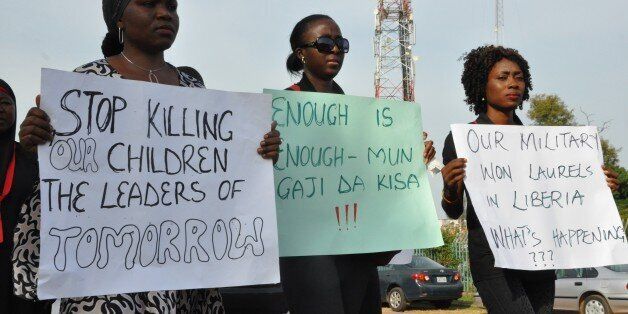 A civil society group carrying posters march on November 17, 2014 to protest the killing of over 47 students of Portiskum Government Comprehensive School in Yobe State, during an Assembly ground on November 10, 2014. A suspected Boko Haram suicide bomber disguised in school uniform killed 47 students in northeast Nigeria , in one of the worst attacks against schools teaching a so-called Western curriculum.The explosion ripped through an all-boys school in Potiskum just as students gathered for morning assembly before classes began, causing panic and chaos. AFP PHOTO/STRINGER (Photo credit should read STR/AFP/Getty Images)