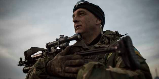 A Ukrainian military officer who goes by the name of Sobol, speaks to journalists in the village of Shyrokyne near Mariupol, eastern Ukraine, Wednesday, Feb. 25, 2015. Russia-backed rebels continued testing Ukrainian defensesÂ atÂ the village of Shyrokyne, near the strategic port city of Mariupol. (AP Photo/Evgeniy Maloletka)