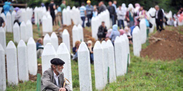 An elderly Bosnian Muslim man, survivor of the Srebrenica 1995 massacre, pays his respects at a relative's grave at the Srebrenica-Potocari Genocide Memorial cemetery in the village of Potocari near the eastern-Bosnian town of Srebrenica, on July 11, 2014. Several thousand people gathered on July 11 in Srebrenica for the 19th anniversary of the massacre of some 8,000 Muslim males by ethnic Serbs forces, Europe's worst atrocity since World War II. A total of 175 newly-identified massacre victims will be laid to rest after a commemoration ceremony held in Potocari, just outside the ill-fated Bosnian town. AFP PHOTO / ELVIS BARUKCIC (Photo credit should read ELVIS BARUKCIC/AFP/Getty Images)
