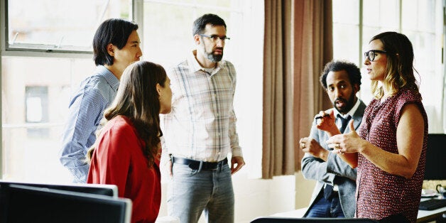 Businesswoman leading project discussion in architects office