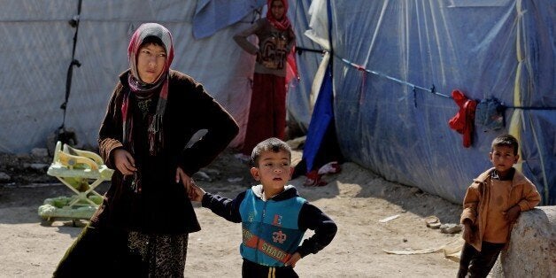 Iraqi refugees who fled from Tikrit and other towns after the advance of Islamic militants, settle at a camp for displaced Ir