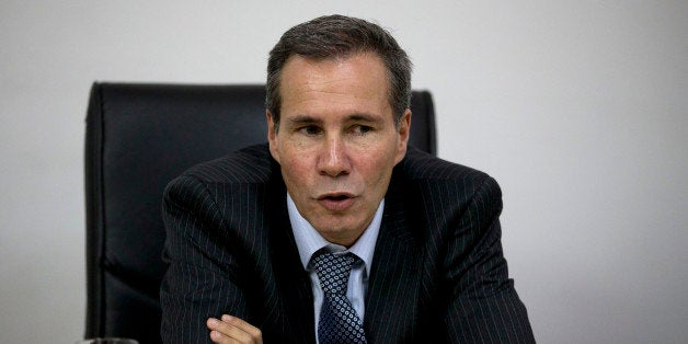 In this May 29, 2013 photo, Alberto Nisman, the prosecutor investigating the 1994 bombing of the Argentine-Israeli Mutual Association community center, talks to journalists in Buenos Aires, Argentina. Nisman who accused the government of secret deals with Iran over the investigation was found shot dead at his apartment early Monday Jan. 19, 2014. He was due to participate in a closed-door session with Congress Monday over his claim last week that de Kirchner and Foreign Minister Hector Timerman covered up a deal with Iran. (AP Photo/Natacha Pisarenko)