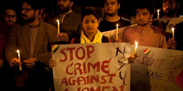 Indian youth hold candles during a protest against sexual violence in New Delhi, India, Monday, Feb. 9, 2015.Police were searching Monday for a man who raped a Japanese student sightseeing in northern India, while elsewhere they announced the arrest of eight men suspected of brutally raping and killing a Nepalese woman, as India authorities continue to struggle to address chronic sexual violence. (AP Photo/ Tsering Topgyal)