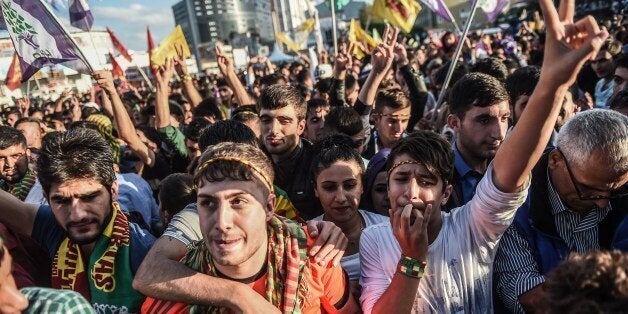 Supporters cheer to Selahattin Demirtas (not pictured), leader of pro-Kurdish Peoples' Democracy Party (HDP), during a rally as part of the election campaign on October 9, 2015 in Istanbul. Turkey holds snap elections on November 1 after coalition talks failed. AFP PHOTO / OZAN KOSE (Photo credit should read OZAN KOSE/AFP/Getty Images)