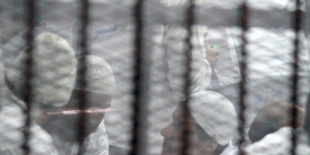 CAIRO, EGYPT - MARCH 05: Defendants seen inside of defendants cage during Ansar Beit Al-Maqdis trial at Police Academy in Tora district of Cairo, Egypt on March 05, 2015. (Photo by Ahmed Gamil/Anadolu Agency/Getty Images)