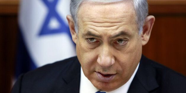 Israeli Prime Minister Benjamin Netanyahu chairs the weekly cabinet meeting at his Jerusalem office, Sunday, March 8, 2015. Tens of thousands of Israelis gathered Saturday night at a Tel Aviv square under the banner "Israel wants change" and called for Netanyahu to be replaced in March 17 national elections. (AP Photo/Gali Tibbon, Pool)