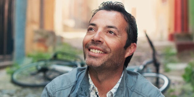 Handsome man and a bicycle in the smal italian city.