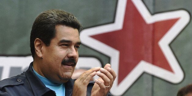 Venezuelan President Nicolas Maduro applauds during a ceremony commemorating the second anniversary of former Venezuelan president Hugo Chavez's death in Caracas on March 5, 2015. AFP PHOTO/JUAN BARRETO (Photo credit should read JUAN BARRETO/AFP/Getty Images)