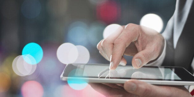 Businessman using digital tablet, close up