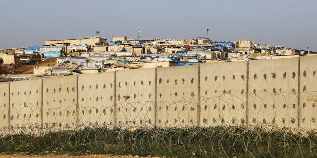 HATAY, TURKEY - MARCH 9: 3 meters in height and 500 meters long wall was built between Turkey-Syria border near the refugee camp near Atme town of Syria to prevent crossing the border without permission, March 9, 2015. (Photo by Cem Genco/Anadolu Agency/Getty Images)