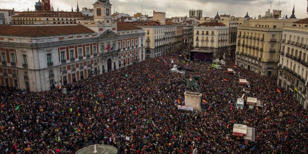 People gather in the main square of Madrid during a Podemos (We Can) party march in Madrid, Spain, Saturday, Jan. 31, 2015. T