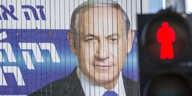 A giant campaign billboard rotates showing Israeli Prime Minister and Likud party's candidate running for general elections,