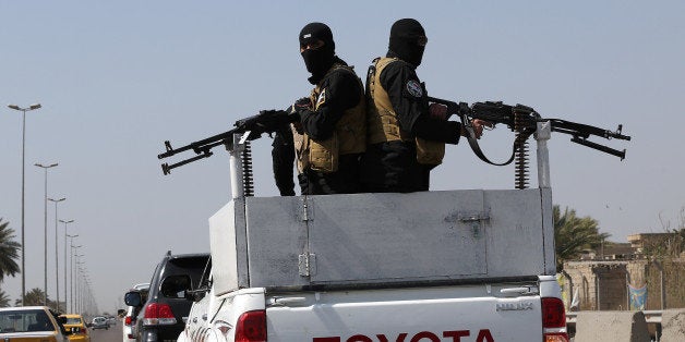 Members of Peace Brigades, a Shiite militia group loyal to Shiite cleric Muqtada al-Sadr, heading to Tikrit, where Iraqi troops backed by Shiite fighters and Iranian advisers are fighting extremists, drive off Baghdad, Iraq, Sunday, March 15, 2015. Dozens of fighters with the militia loyal to the radical Shiite cleric left Iraq's capital Sunday to take part in an offensive to capture Tikrit from the Islamic State group. (AP Photo/Karim Kadim)