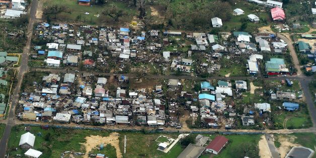 Damage to houses in Port Vila, Vanuatu is seen from the air in the aftermath of Cyclone Pam Monday, March 16, 2015. Vanuatu's President Baldwin Lonsdale said Monday that the cyclone that hammered the tiny South Pacific archipelago over the weekend was a "monster" that has destroyed or damaged 90 percent of the buildings in the capital and has forced the nation to start anew. (AP Photo/Dave Hunt, Pool)